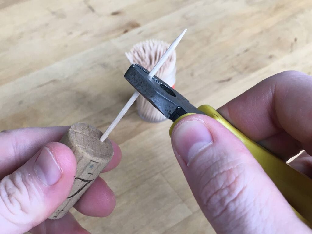 Inserting toothpicks into a cork
